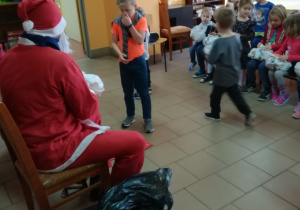 Mikołaj rozdaje prezenty