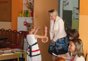 uczennica zawiesza medal na szyi nauczycielce Annie Kaniewskiej